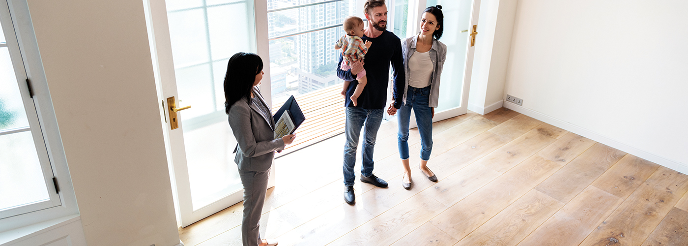 family and realtor touring a house