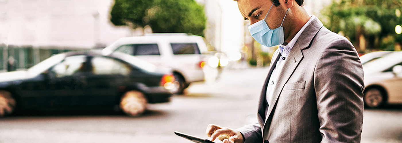 Man on tablet shopping for car with face mask