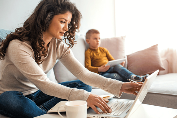 a woman and a man looking at a laptop